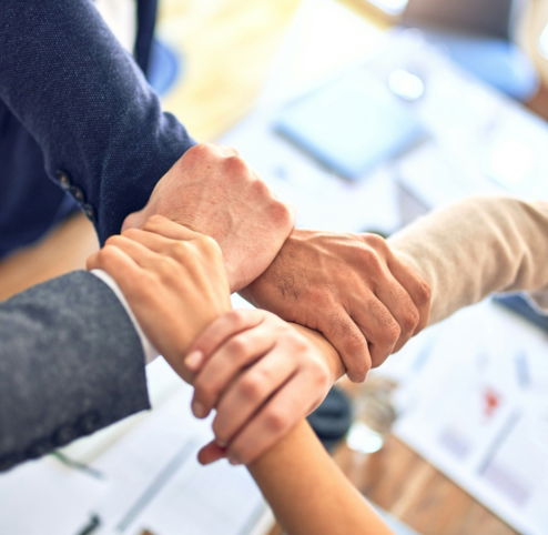 person in black long sleeve shirt holding persons hand